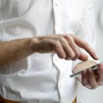 person holding white Android smartphone in white shirt