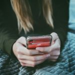 woman holding red and silver can