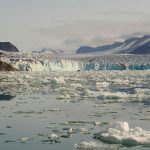 a group of ice floes floating on top of a body of water