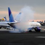 an airplane is on the runway with a lot of smoke coming out of it