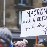 a group of people holding a protest sign