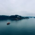 a couple of boats floating on top of a large body of water