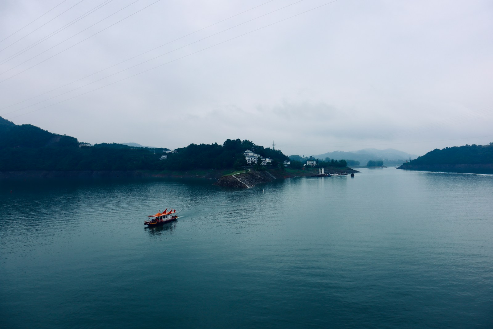 a couple of boats floating on top of a large body of water