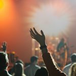 shallow focus photography of hand and people