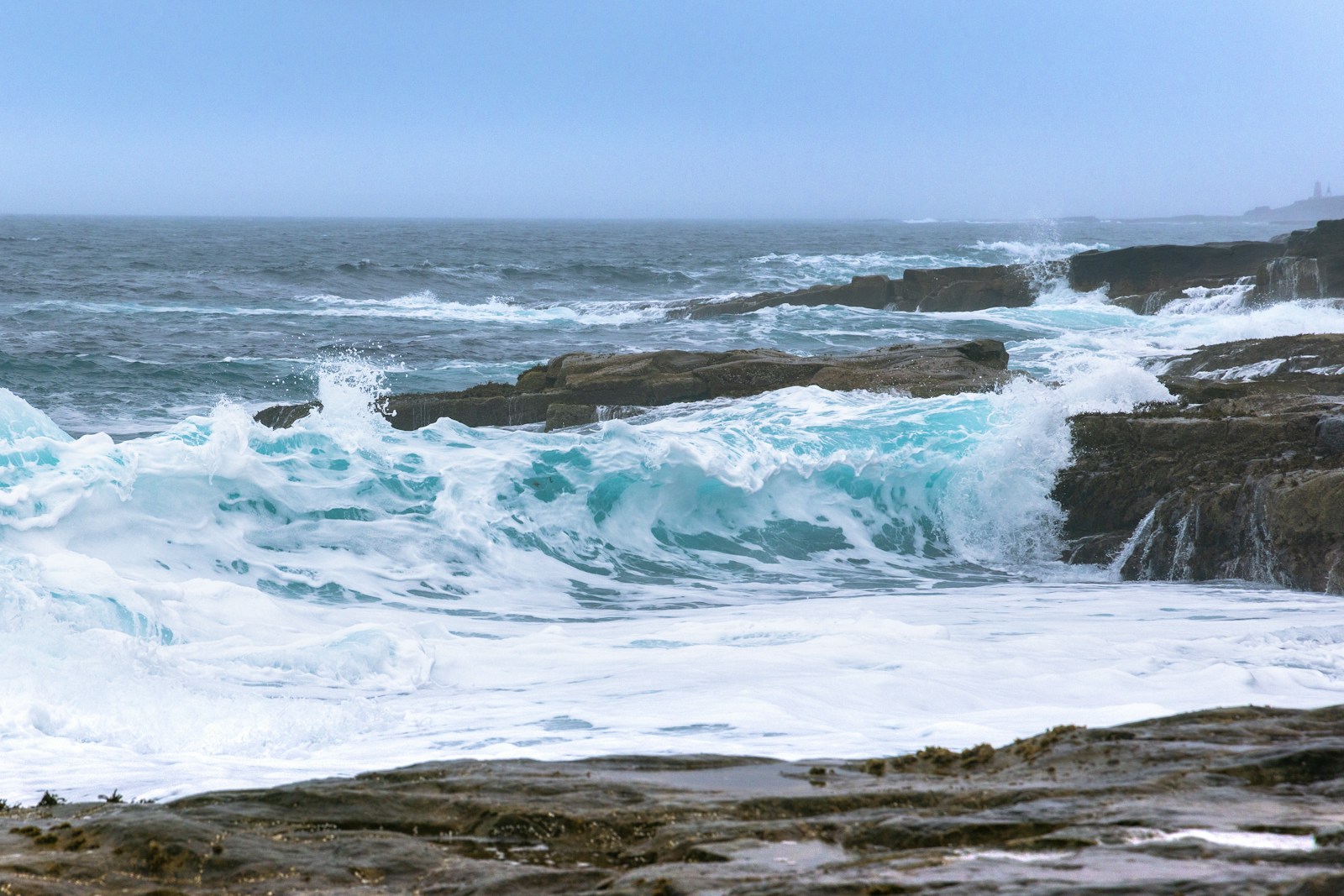 a person riding a surfboard on top of a wave