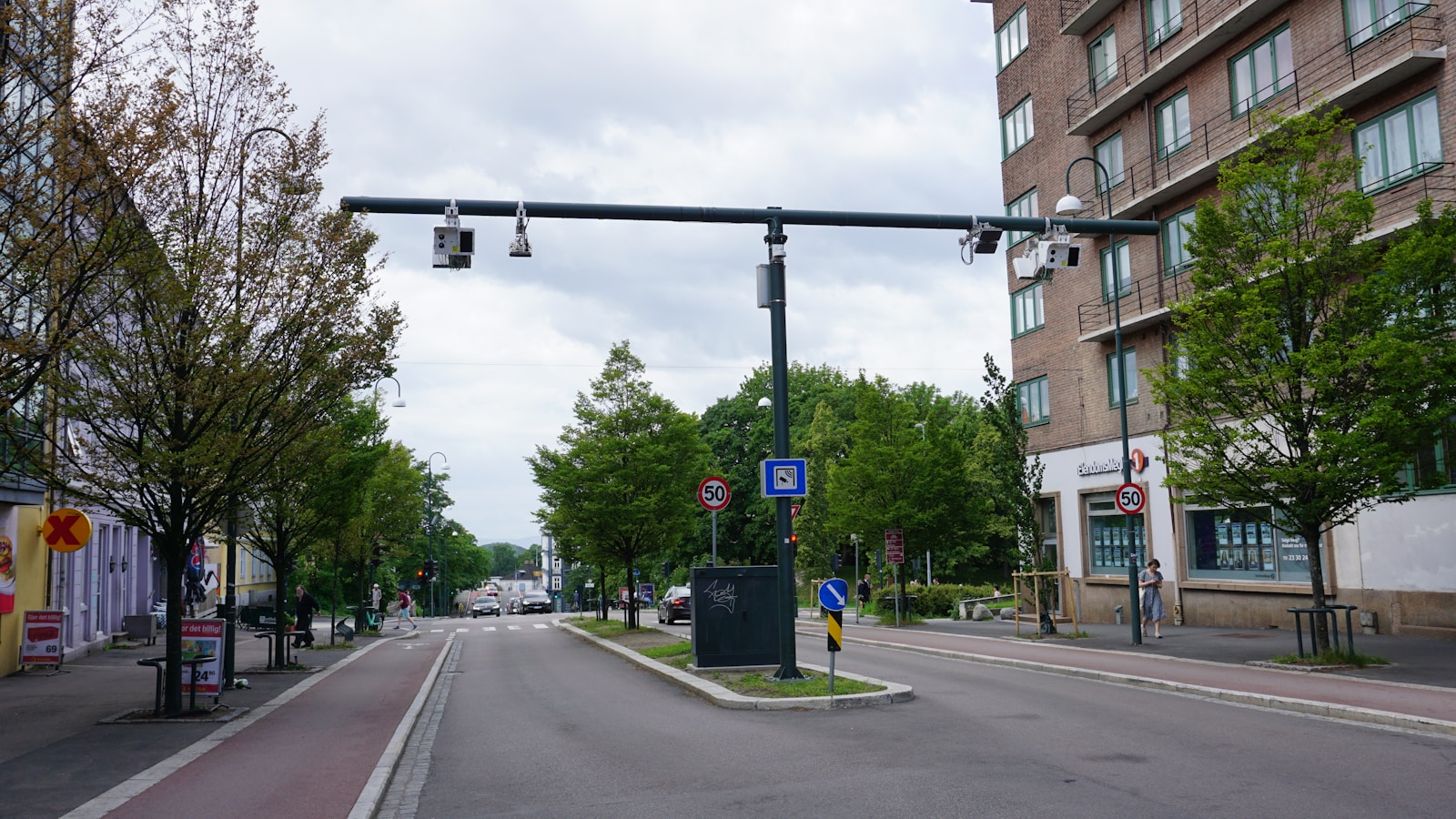 a street with a traffic light on the side of it