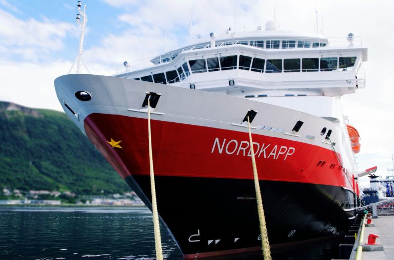 white and red ship on sea during daytime