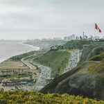 a view of a city from a hill overlooking the ocean