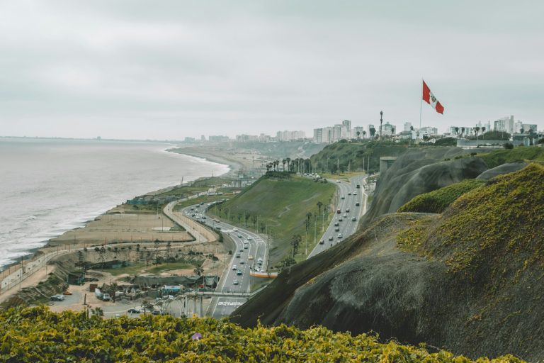 a view of a city from a hill overlooking the ocean