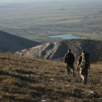 2 men hiking on mountain during daytime