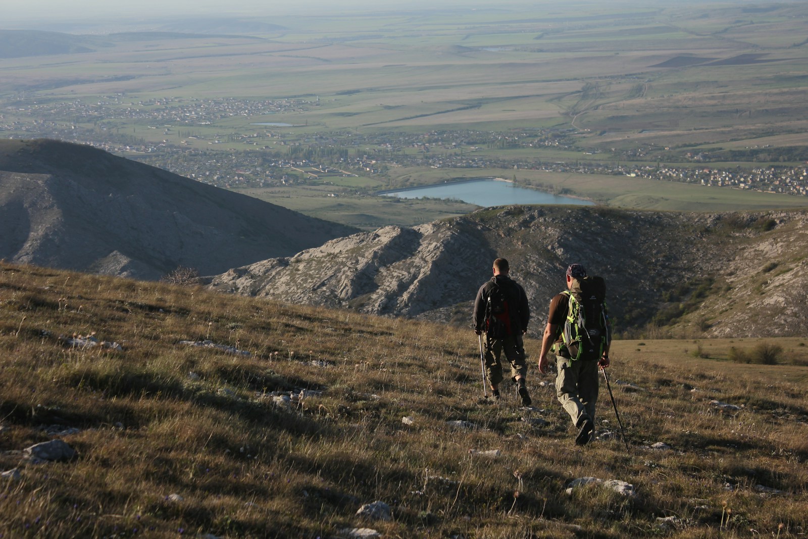 2 men hiking on mountain during daytime