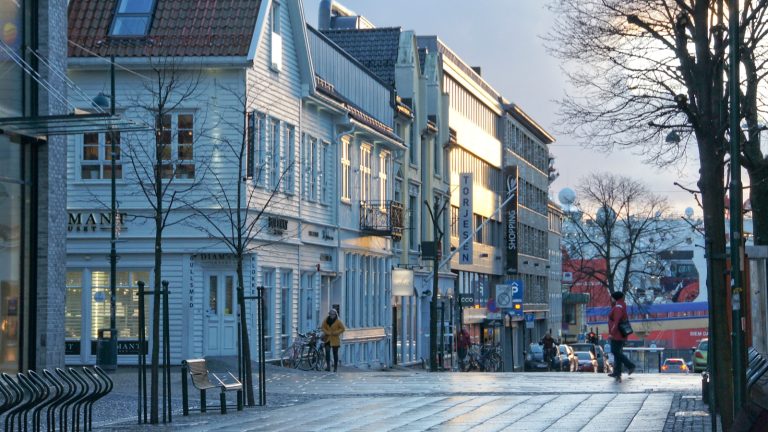 people walking on sidewalk near buildings during daytime