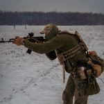 a man with a rifle in the snow