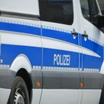 white and blue bus on road