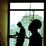 two men wearing hard hat standing near clear glass window