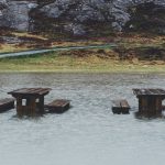 brown wooden table covered on body of water