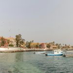 a group of boats floating on top of a body of water