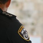 a police officer is standing in front of a wall