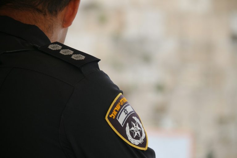 a police officer is standing in front of a wall