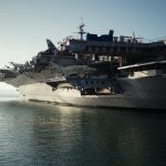 gray warship on body of water