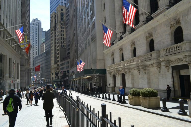 people walking on a street with flags