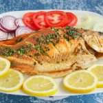 a plate of fish and lemons