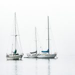 three white boats on sea during daytime