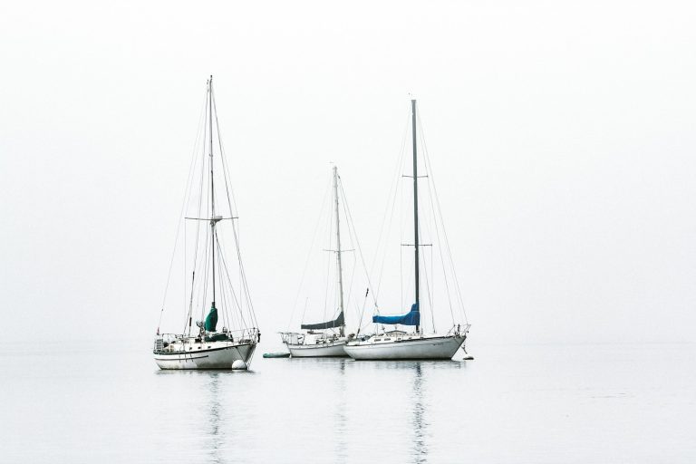 three white boats on sea during daytime