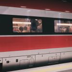 group of people inside red and gray train