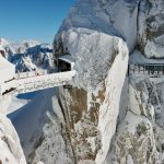 a bridge that is on top of a snowy mountain