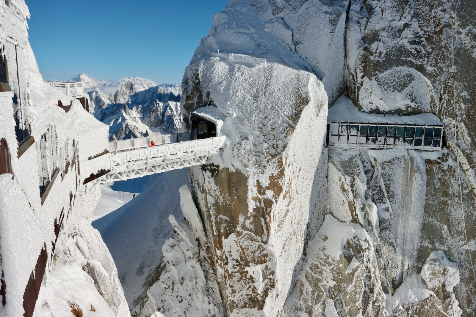 a bridge that is on top of a snowy mountain