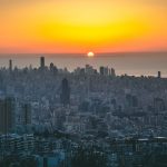 city skyline during sunset with orange sky