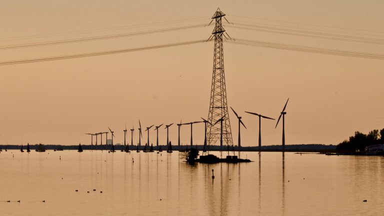 Windmill Near Electric Pylon