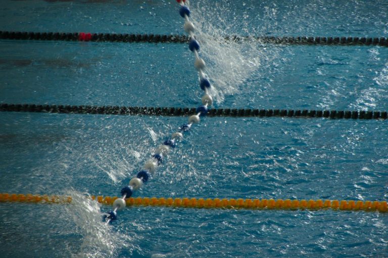 a swimming pool with water splashing on the side of it