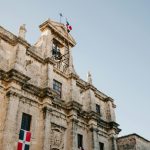 Facade of old building with flag of Dominican Republic