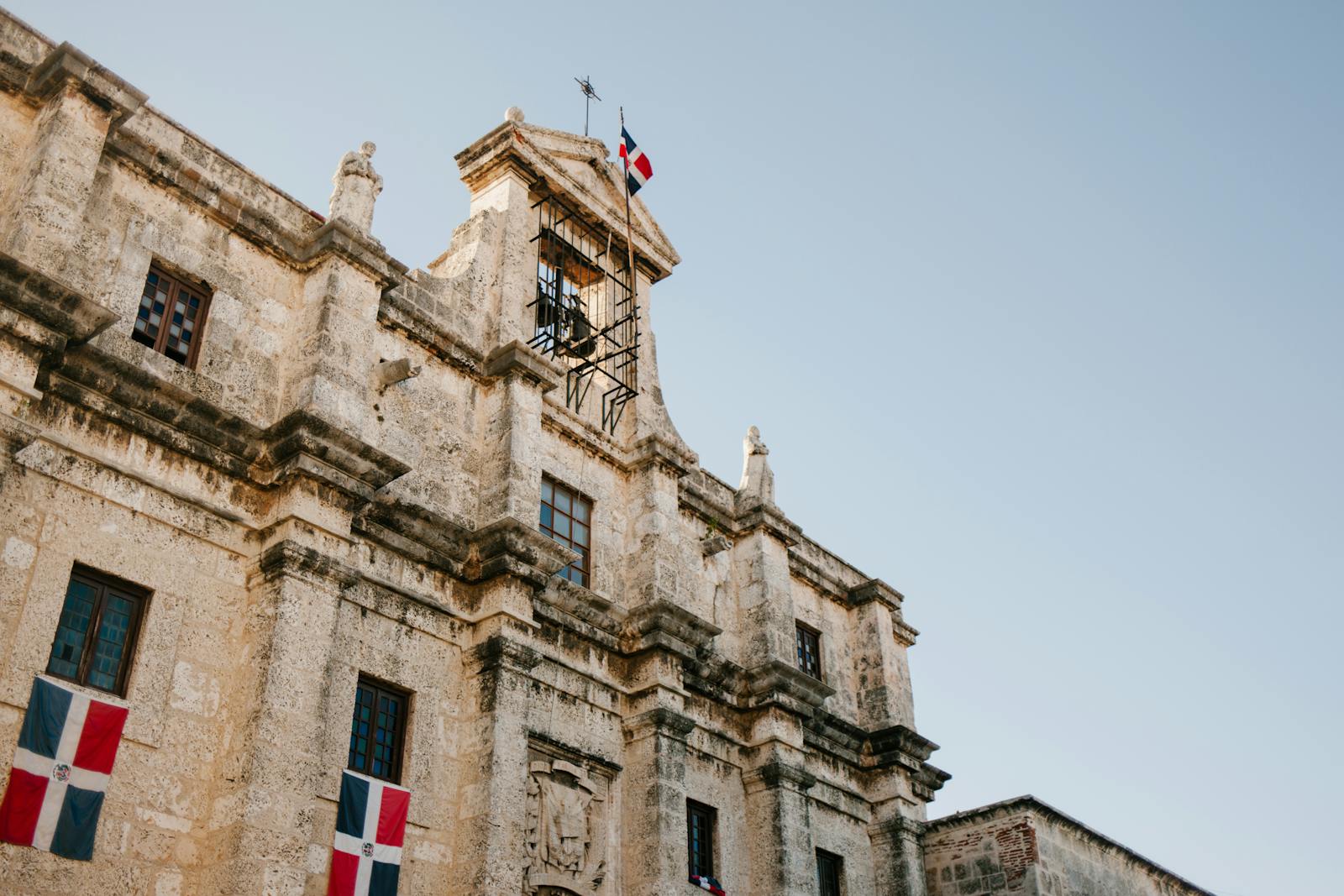 Facade of old building with flag of Dominican Republic