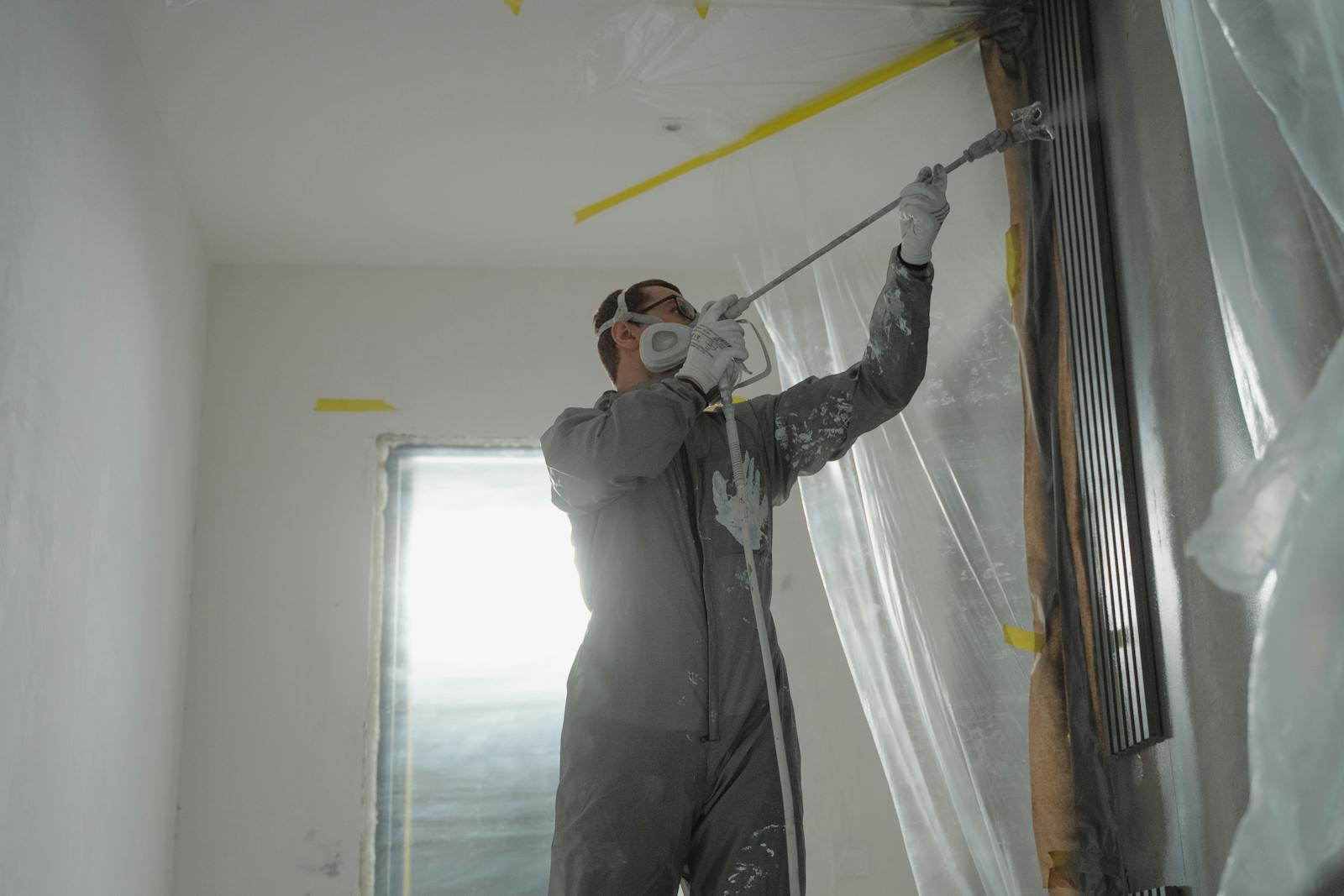 Man in Black Jacket Holding Black Rope