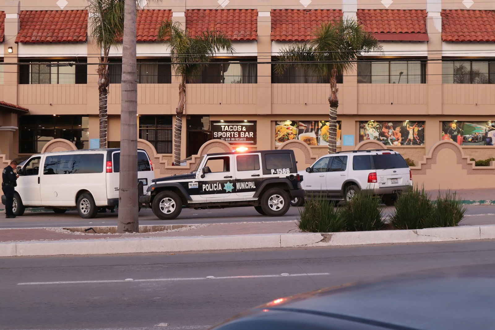 two police cars parked on the side of the road