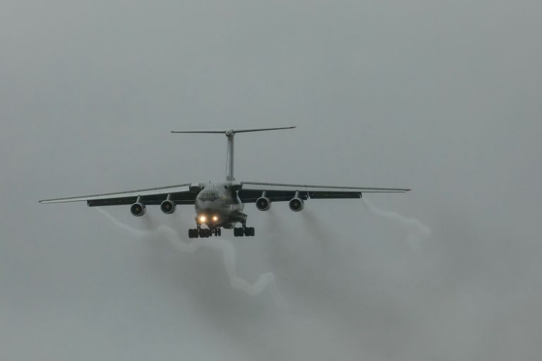 a large jetliner flying through a cloudy sky