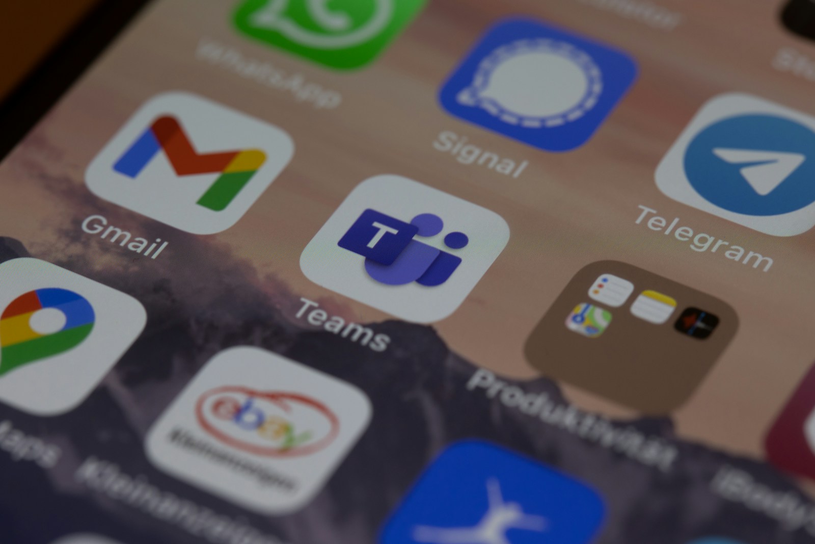 Iphone som viser ulike apper i blå og grønne fager