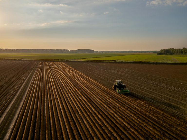 En traktor pløyer på et jorde