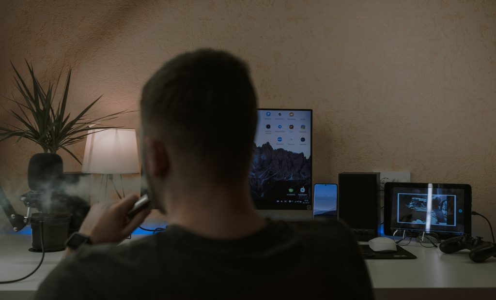 En person som sitter foran PC og snakker
