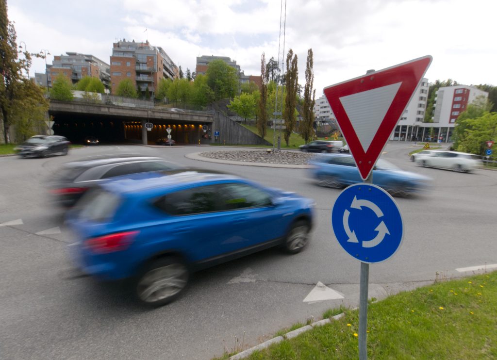 Rundkjøring hvor en blå bil kjører
